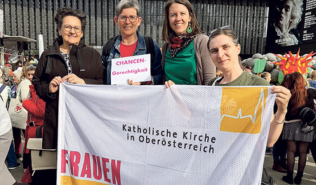 Mitglieder der Frauenkommission mit ihrer neuen Fahne bei der Kundgebung am Weltfrauentag. 