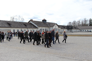 Ein Teil der Gruppe mit Bischof Manfred Scheuer auf dem Lagergelände von Dachau. Gedenken bei der großen Glocke, dahinter die Todesangst-Christi-Kapelle.